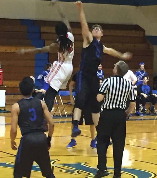 Jim French tosses the opening jump a boys regional game
